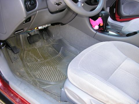 1998 Ford Taurus - Driver's side interior view of a 1998 Ford Taurus, focusing on the floor mats and pedals.