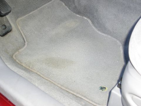 1998 Ford Taurus - Close-up of the driver's side floor mat and pedals inside a vehicle.