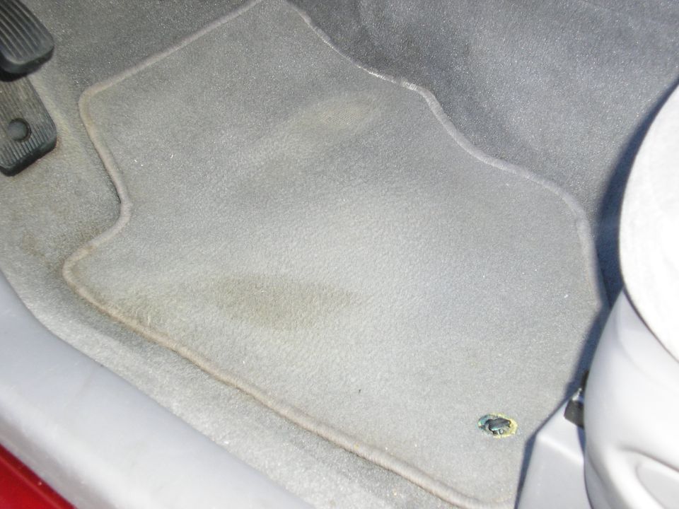Gray interior floor mat with pedals visible