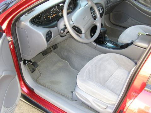 1998 Ford Taurus - Interior view of a 1998 Ford Taurus, highlighting the dashboard, steering wheel, and front seats.