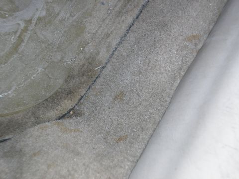 1998 Ford Taurus - Close-up view of the vehicle's interior carpet, showing texture, a seam, and some stains.