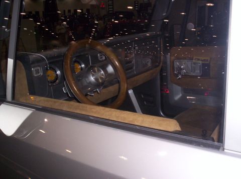 1989 Ford Bronco - The interior of a vehicle is visible, a wood-grain steering wheel and dashboard accents.