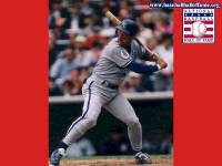 2000 Ford Taurus - Baseball player swings a bat during a game in a stadium.