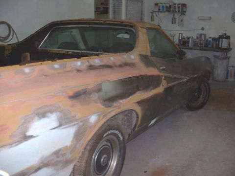 1972 Ford Ranchero - This 1972 Ford Ranchero is undergoing bodywork, showing primer and sanding marks along its side.