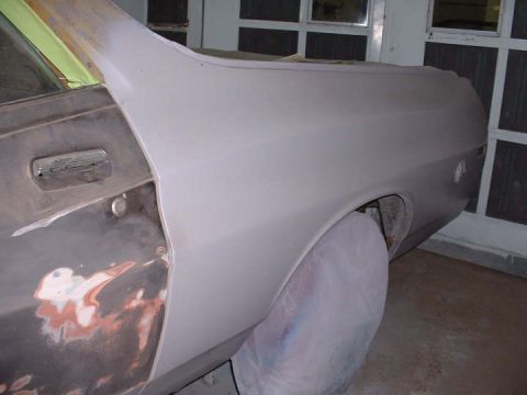 1972 Ford Ranchero - The side of a 1972 Ford Ranchero is shown, with primer and body filler indicating it is in the process of repair.