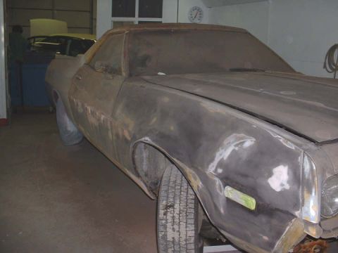 1972 Ford Ranchero - Car body undergoing repairs in a workshop, with another vehicle in the background.