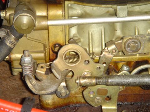 1975 Ford Ranchero - The carburetor linkage shows a throttle arm, springs, and a metal rod. Text on the carburetor reads "P-80".