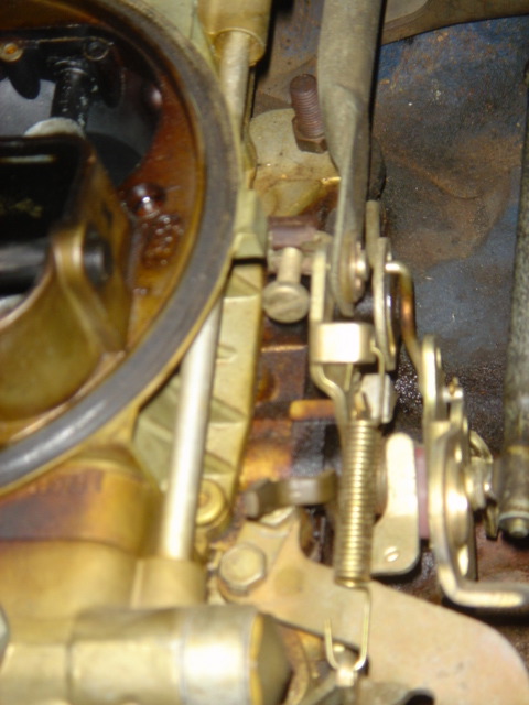 1975 Ford Ranchero - Close-up view of carburetor linkage, showing various mechanical components and springs.