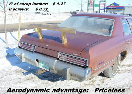 1997 Ford Crown Victoria - A car with a DIY spoiler made of scrap lumber and screws, with a price breakdown visible.