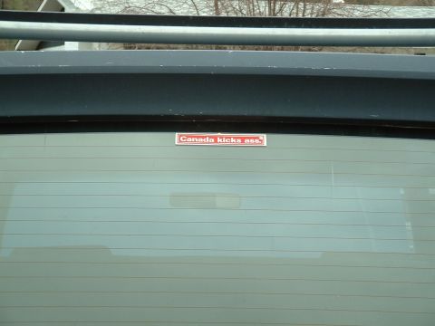1990 Ford Bronco - Vehicle rear window displays a "Canada kicks ass" sticker and a website watermark.