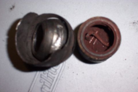 1990 Ford Bronco - A disassembled u-joint and its corresponding cap are shown, indicating a need for replacement.