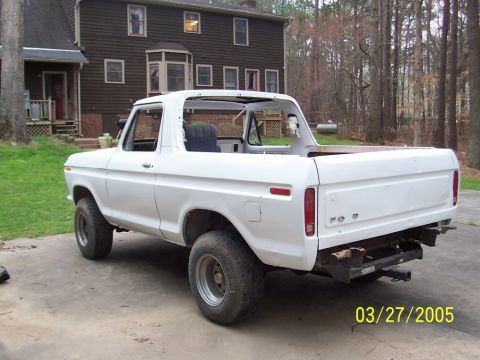 1979 Ford Bronco - This white 1979 Ford Bronco is shown from the rear three-quarter angle, with its roof removed.