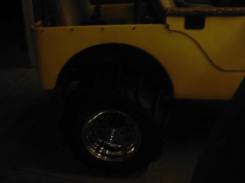 1978 Ford Bronco - This yellow jeep features a textured body and large off-road tires, with a chrome wheel visible.