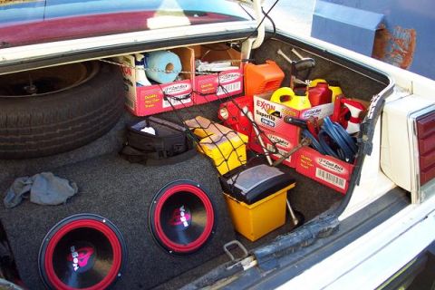 1985 Ford Crown Victoria LTD - The trunk of a 1985 Ford Crown Victoria LTD is filled with various items, including audio equipment and supplies.