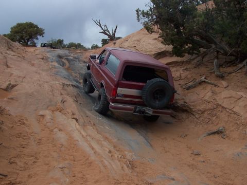 1991 Ford Bronco - A red 1991 Ford Bronco navigates a challenging rocky trail during the Moab Easter Jeep Safari in 2005.