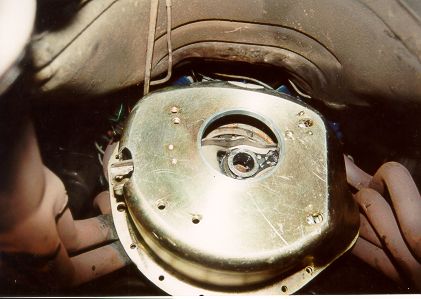 1971 Ford Mustang - Underside view of a vehicle's transmission bell housing and exhaust manifold.