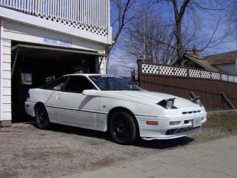 1989 Ford Probe - White 1989 Ford Probe with pop-up headlights visible.