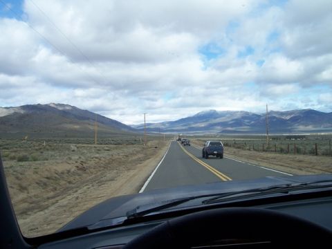 1989 Ford Bronco - Driving on a highway through a mountainous landscape with several vehicles on the road.