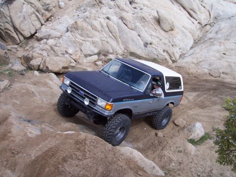 1989 Ford Bronco - Ford Bronco navigates a challenging rocky trail during an off-road excursion.