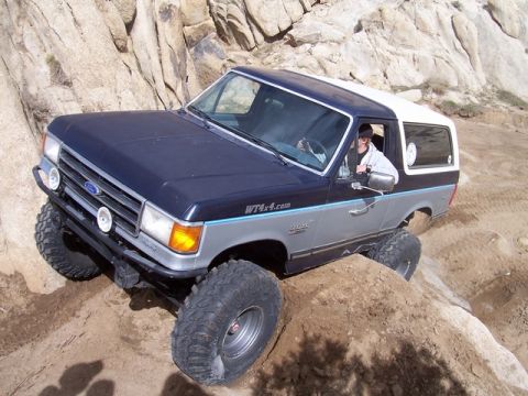 1989 Ford Bronco - A Ford Bronco navigates a rocky, off-road trail.