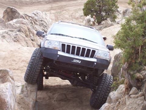 1989 Ford Bronco - This modified Jeep Grand Cherokee navigates a rocky off-road course, its articulation and off-road tires.