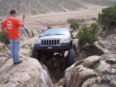 1989 Ford Bronco - A modified Jeep Grand Cherokee carefully maneuvers through a rocky off-road course.