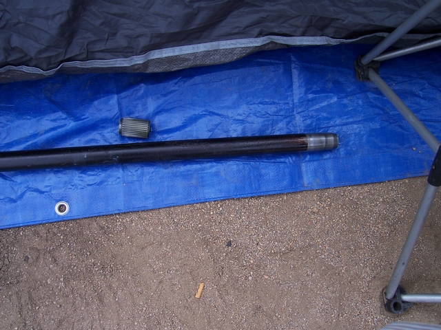 Driveshaft and U-joint on blue tarp