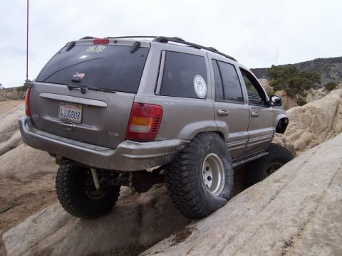1989 Ford Bronco - This Jeep Grand Cherokee is navigating a rocky trail, its off-road capabilities.