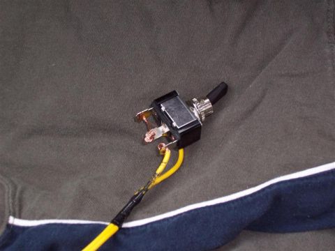2001 Ford Taurus - A close-up view of a toggle switch with yellow wires, likely a replacement part.