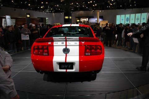 2005 Ford Mustang - A red and white 2005 Ford Mustang Shelby SVT is displayed at an auto show.