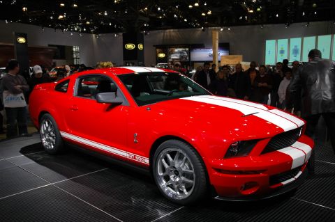 2005 Ford Mustang - Red 2005 Ford Mustang GT 500 on display at an auto show.