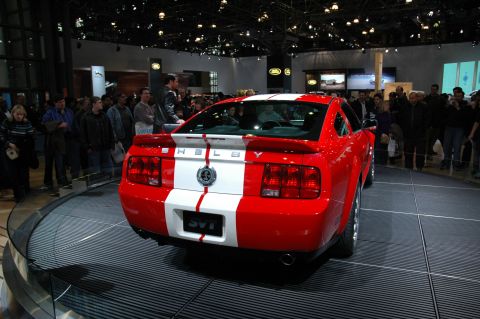 2005 Ford Mustang - A red 2005 Ford Mustang Shelby GT is displayed at an auto show.