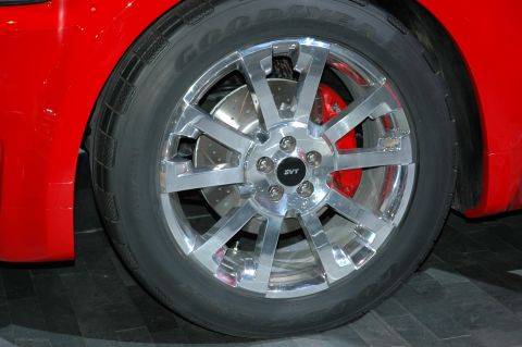2005 Ford Mustang - SVT wheel and red brake caliper on a red Ford Mustang.