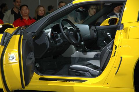 2005 Ford Mustang - Interior view of a yellow sports car, showing the driver's seat and dashboard details.