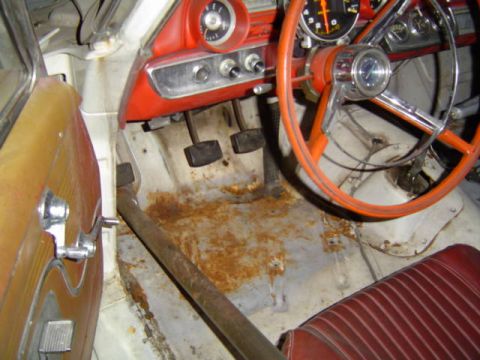 1963 Ford Galaxie - Interior view of a 1963 Ford Galaxie, showing the steering wheel, seats, and floor pan.