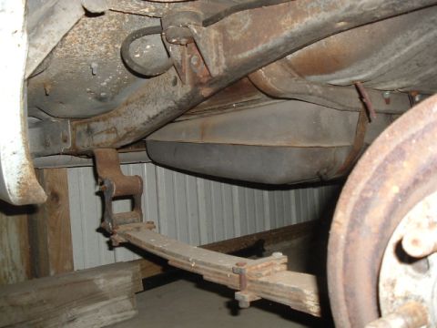 1963 Ford Galaxie - The underside of a vehicle reveals its suspension and fuel tank, suggesting a restoration project.