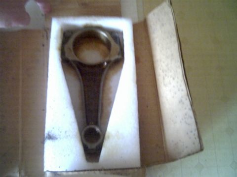 1963 Ford Galaxie - A single connecting rod is presented in a cardboard box, cushioned by white foam for protection.