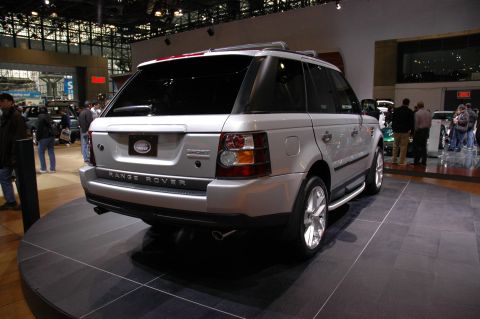 2005 Ford Mustang - Rear view of a silver Range Rover Sport on display at an auto show.