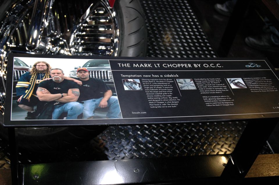 Sign about The Mark LT Chopper by O.C.C. with a photo of three men