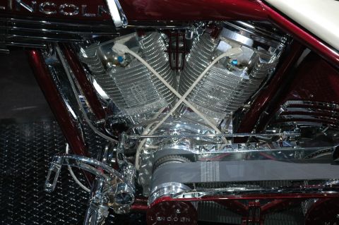 2005 Ford Mustang - Close-up of a highly polished V-twin engine, ribbed cylinders and a prominent drive belt.