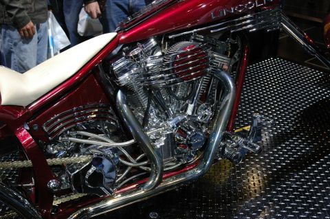 2005 Ford Mustang - A detailed view of a custom motorcycle's engine and seat, intricate chrome work and a vibrant red finish.