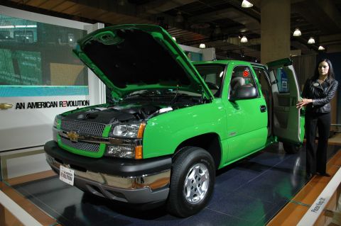 2005 Ford Mustang - A bright green Chevrolet Silverado pickup truck is displayed with its hood and doors open, inviting inspection.