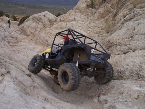 1989 Ford Bronco - Custom off-road buggy navigates a steep, rocky terrain during an outdoor adventure.
