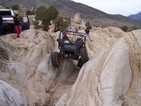 1989 Ford Bronco - Vehicles tackle challenging rocky terrain during an off-road excursion.