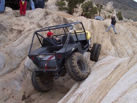 1989 Ford Bronco - Custom off-road buggy navigates a steep rock climb during a Spring Break event.