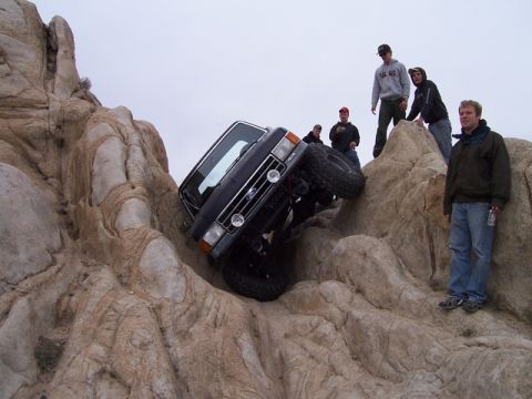 1989 Ford Bronco - Bronco tackling a difficult rock climb with onlookers.