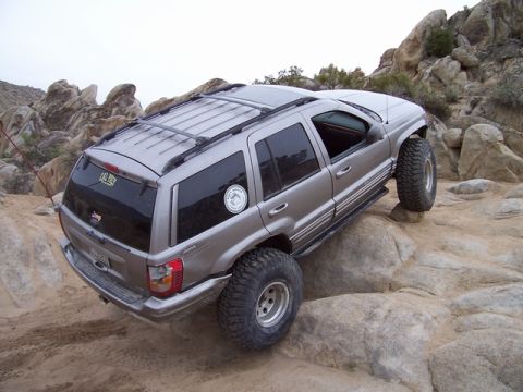 1989 Ford Bronco - This Jeep Grand Cherokee is navigating a rocky trail, demonstrating its off-road capabilities.