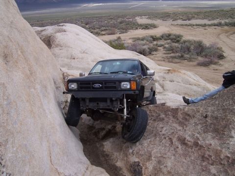 1989 Ford Bronco - 1989 Ford Bronco navigating a rocky trail during an off-road excursion.