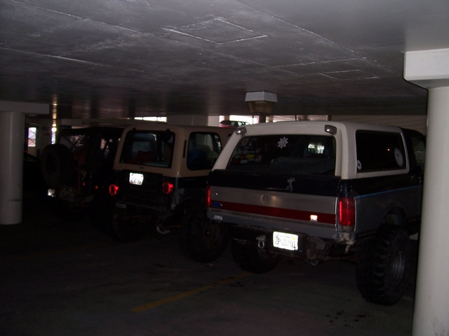 Two-tone Ford Bronco with a white top and blue/grey body, seen from the rear