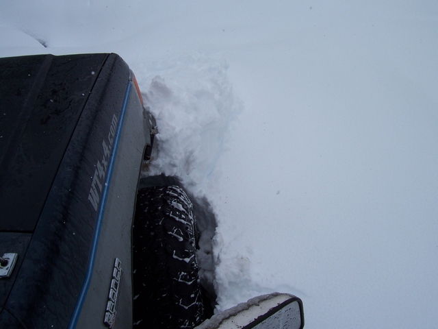 1989 Ford Bronco side view stuck in deep snow, with 'WTA4x4.com' visible on the door